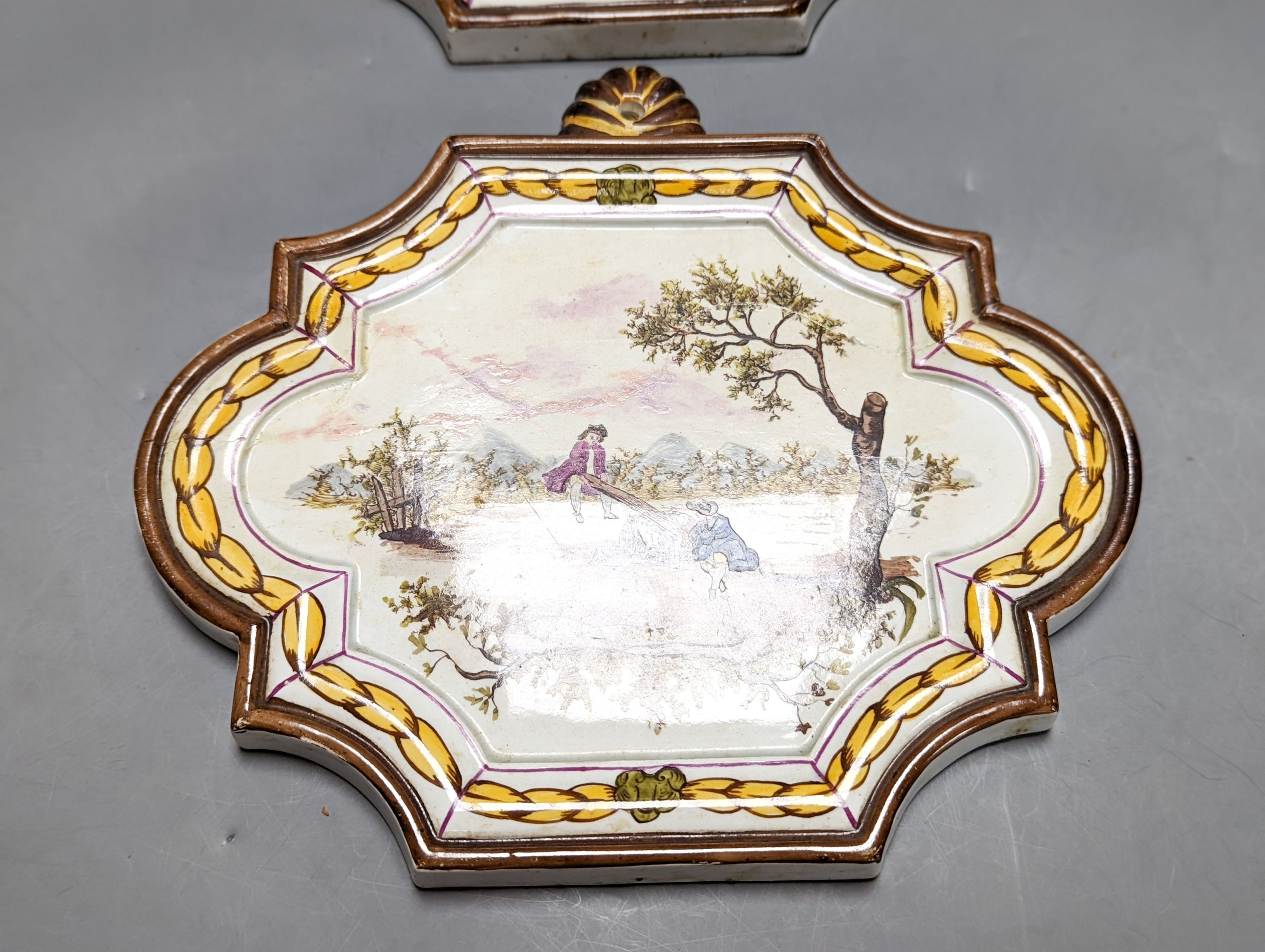 A pair of 19th century painted faience plaques in the style of Veuve Perrin 23cm